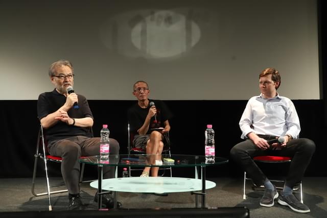 黒沢清監督（左）のフィルモグラフィをたどるクレモン・ロジェ氏（右）