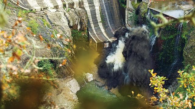 爆破し、撤去されるダム